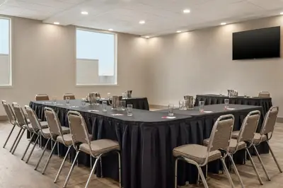 a conference room with a long table and chairs at Canalta Airdrie in Airdrie