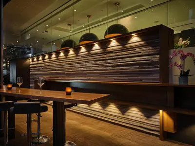 a restaurant with a table and a wall with lights at Hotel Le Germain Calgary in Calgary
