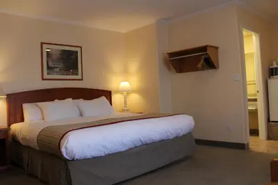a hotel room with a large bed in a room at Travelodge by Wyndham Kamloops in Kamloops