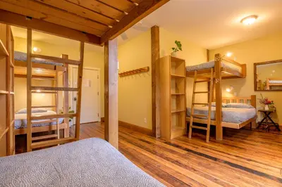 a room with two bunk beds and a hallway at Riding Fool Accommodation in Cumberland