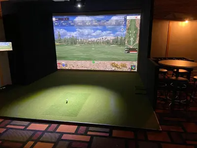 a large screen television with a video game on it at Vegreville Garden Inn in Vegreville