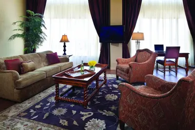 a living room with a couch and chairs and a table at Red Deer Resort & Casino in Red Deer