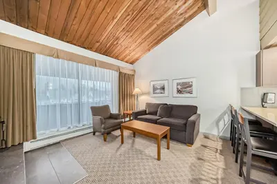 a living room with a couch and a table at Jasper Inn & Suites by INNhotels in Jasper