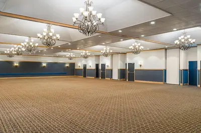 a large room with a large ballroom with chandeliers at Sternwheeler Hotel & Conference Centre, Trademark by Wyndham in Whitehorse