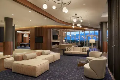 a living room with couches and chairs in a building at Courtyard by Marriott Calgary Airport in Calgary