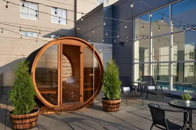 a wooden barrel sitting on a patio next to a building at Residence Inn by Marriott Calgary Airport in Calgary