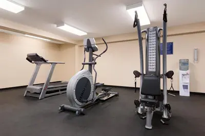 a gym with two exercise bikes and tread machines at High Prairie Inn in High Prairie