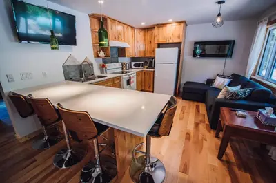 a kitchen and living room with a table and a couch at Grizzly Paw B&B in Clearwater