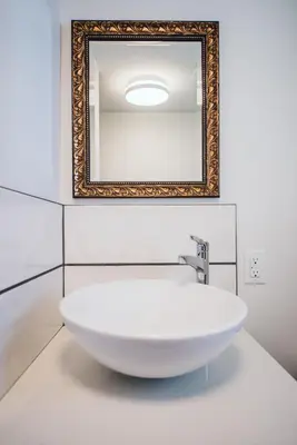 a white sink in a bathroom with a mirror at Grizzly Paw B&B in Clearwater
