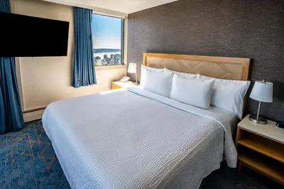 a hotel room with a large bed and a window at Blue Horizon Hotel in Vancouver