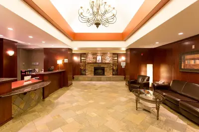 a living room with a couch and a fireplace at Holiday Inn Express Hotel & Suites - Slave Lake by IHG in Slave Lake