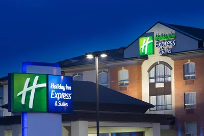 a hotel with two signs on the front of it at Holiday Inn Express Hotel & Suites - Slave Lake by IHG in Slave Lake