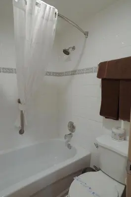 a bathroom with a white tub and a toilet at Canadas Best Value Inn and Suites Fernie in Fernie