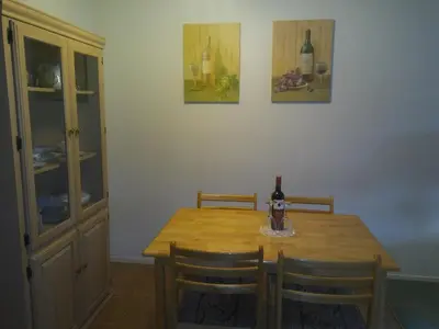 a dining room table with a bottle of wine on it at Rosedale Manor in Duncan