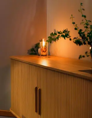 a candle is sitting on top of a cabinet at Snug Harbour Inn in Ucluelet