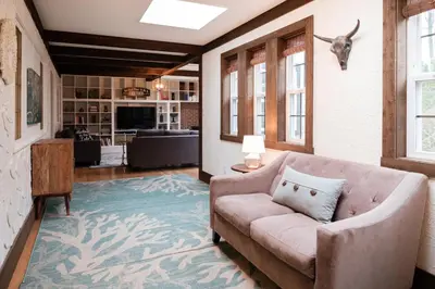 a living room with a couch and a table at Bramblebank Cottages in Harrison Hot Springs