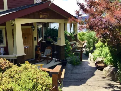 a porch of a house with a bench on a sidewalk at The Tuwanek Bed and Breakfast in Sechelt