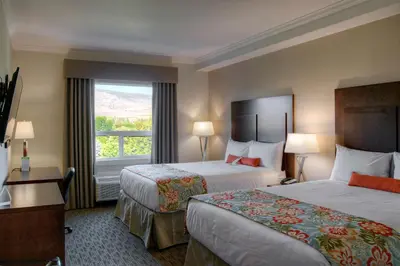 a hotel room with two beds and a window at Coast Oliver Hotel in Oliver