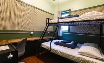 a room with two bunk beds and a chair at The Cambie Hostel Seymour in Vancouver
