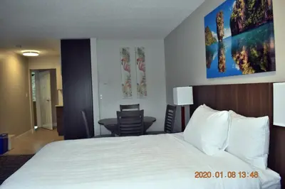 a hotel room with a bed and a table and chairs at High Point Resort in Quathiaski Cove