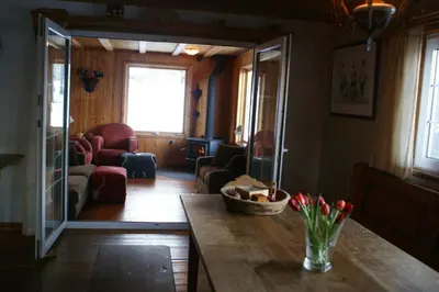 a living room with a table and a living room with a couch at Alpenglow Bed and Breakfast in Kimberley