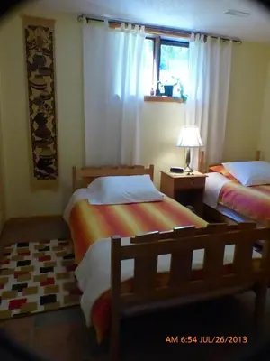 a bedroom with two beds and a window at End of the road B & B in Cranbrook