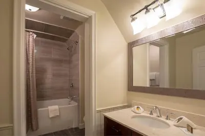 a bathroom with a sink and a tub and a mirror at Banff Boutique Inn - Adults only in Banff