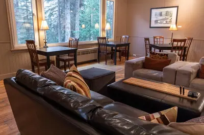 a living room with a leather couch and a table at Banff Boutique Inn - Adults only in Banff