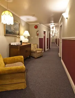 a hallway with couches and chairs in a hotel room at Heriot Bay Inn in Heriot Bay