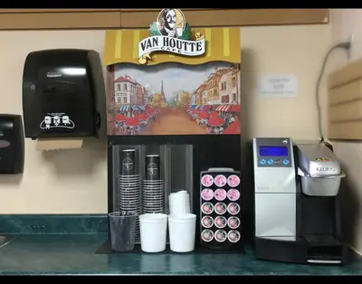 a cashiers counter with a drink dispenser and a starbucks at Kootenay Country Inn in Cranbrook