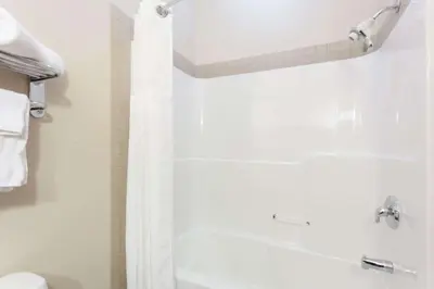 a bathroom with a shower and a toilet at Ramada by Wyndham Westlock in Westlock