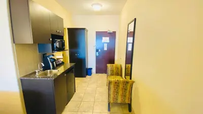 a small kitchen with a sink and a counter at Ramada by Wyndham Westlock in Westlock