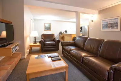 a living room with a leather couch and a coffee table at Panorama Vacation Retreat at Horsethief Lodge in Panorama