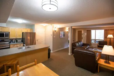 a kitchen and living room with a couch and a table at Panorama Vacation Retreat at Horsethief Lodge in Panorama