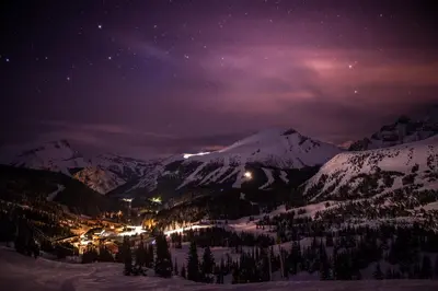 a nightime view of a ski resort in the mountains at Sunshine Mountain Lodge in Banff