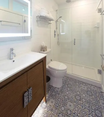 a bathroom with a toilet and a sink and a shower at Artisan Suites on Bowen in Bowen Island