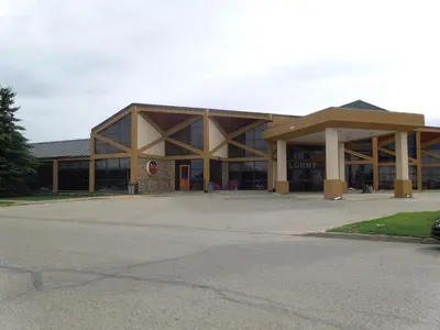 a large building with a parking lot in front of it at Walking Eagle Inn & Lodge in Rocky Mountain House