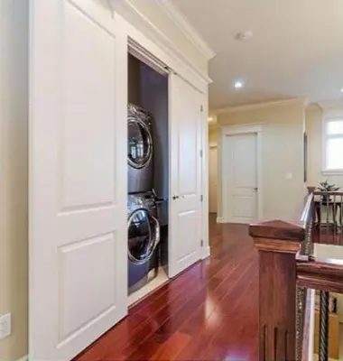 a laundry room with two washes in a wall at Imperial House in Burnaby