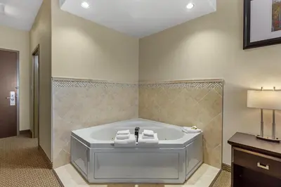 a bathroom with a bath tub in a room at Best Western Plus St Albert in St. Albert