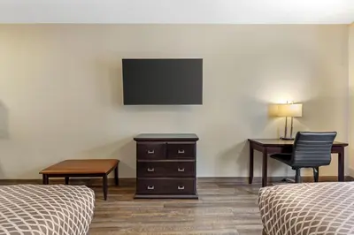 a room with two beds and a desk and a television at Best Western Plus St Albert in St. Albert