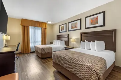 a hotel room with two beds and a television at Best Western Plus St Albert in St. Albert