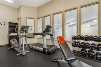 a gym with two treadmills and exercise machines at Best Western Wainwright Inn & Suites in Wainwright