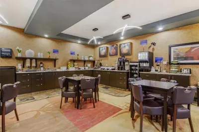 a restaurant with a table and chairs in a room at Best Western Wainwright Inn & Suites in Wainwright