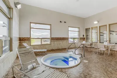 a room with a large tub in the middle of a room at Best Western Wainwright Inn & Suites in Wainwright