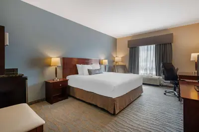 a hotel room with a large bed and a desk at Best Western Rocky Mountain House Inn & Suites in Rocky Mountain House