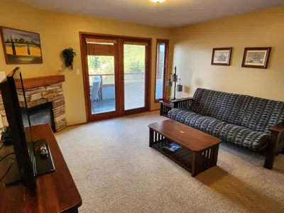 a living room with a couch and a fireplace at Sunshine Coast Resort in Madeira Park