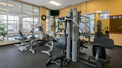 a gym with treadmills and cardio equipment in a building at Best Western Plus Chateau Inn Sylvan Lake in Sylvan Lake