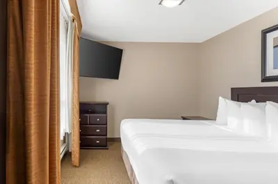 a hotel room with a bed and a window at Best Western Bonnyville Inn & Suites in Bonnyville