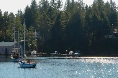 a boat is docked in a body of water at Painted Boat Resort Spa and Marina in Madeira Park