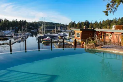 a large swimming pool in front of a marina at Painted Boat Resort Spa and Marina in Madeira Park